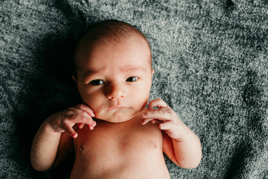 Closeup of a newborn boy wit his eyes wide open